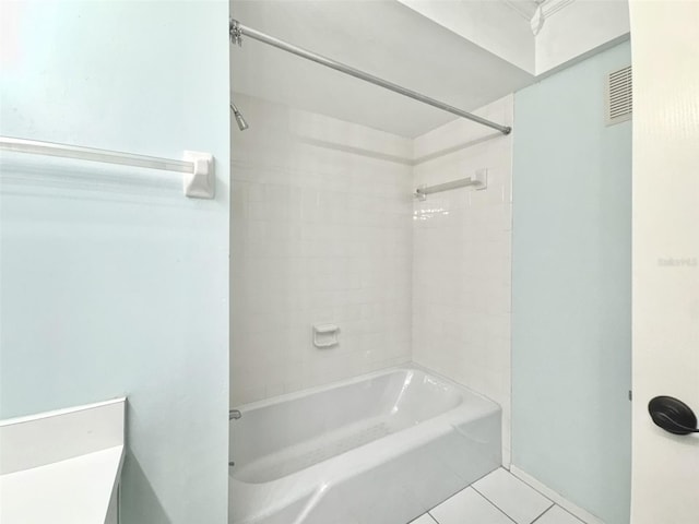 bathroom with tile patterned floors and tiled shower / bath