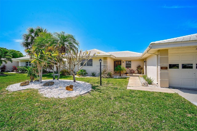 single story home with a front yard and a garage