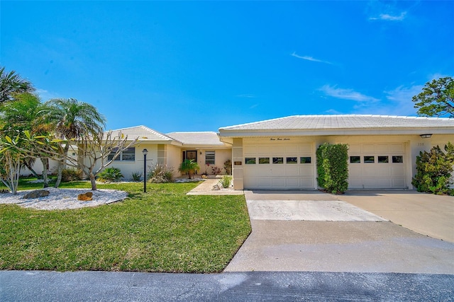 view of front of property with a garage and a front yard