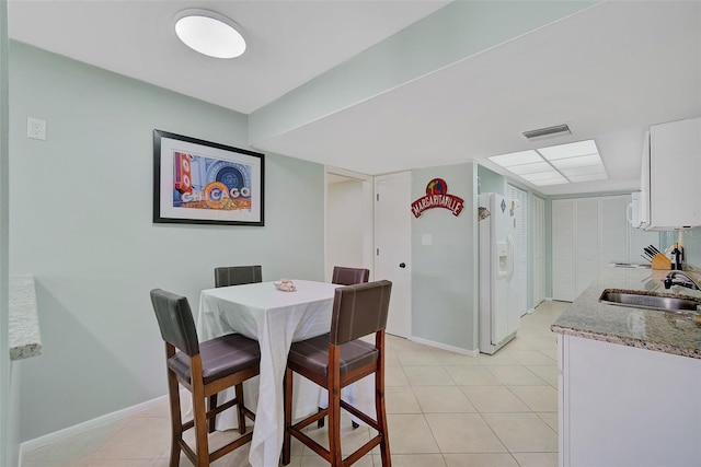 tiled dining area with sink