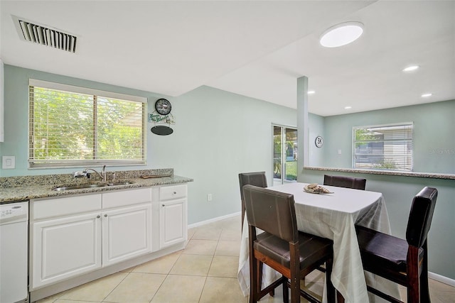 dining area featuring light tile patterned floors and sink