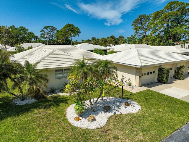 ranch-style home with a garage and a front lawn