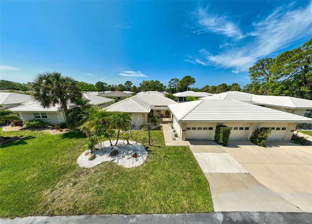 view of front of house with a front yard and a garage