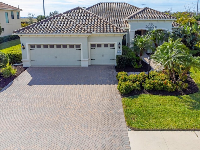 7817 Passionflower Dr, Sarasota, FL 34241 - mediterranean / spanish house featuring a front yard and a garage