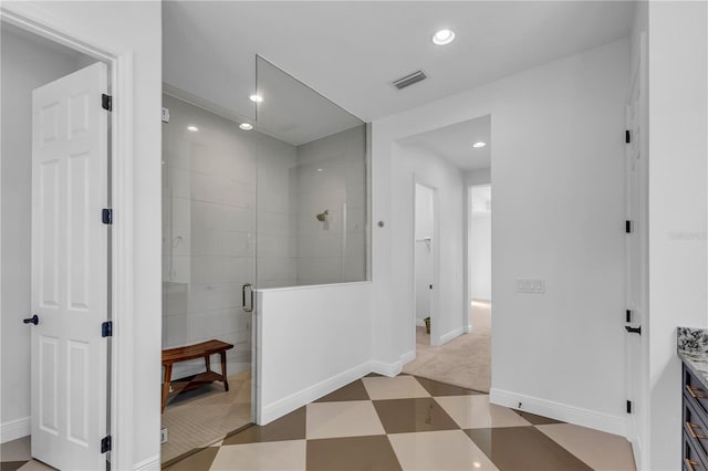 bathroom featuring vanity and a shower with shower door