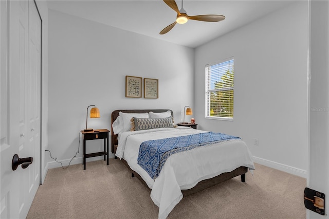 bedroom with light carpet, a closet, and ceiling fan