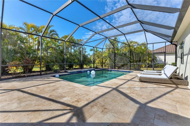 view of pool featuring glass enclosure and a patio