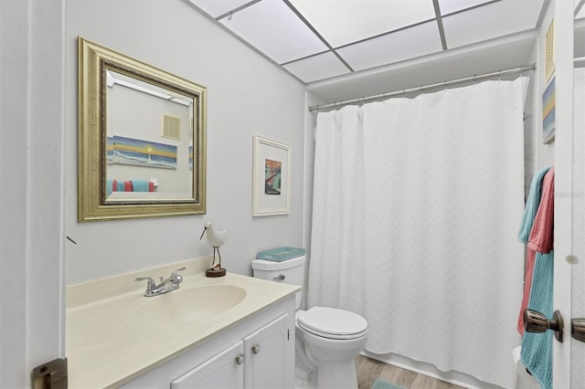 bathroom with hardwood / wood-style floors, vanity, curtained shower, and toilet