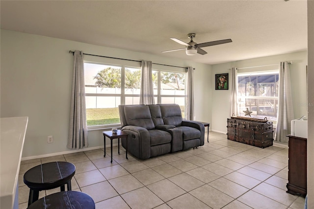 tiled living room with ceiling fan and a wealth of natural light