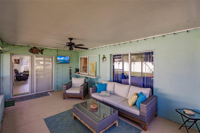 exterior space with ceiling fan and a textured ceiling