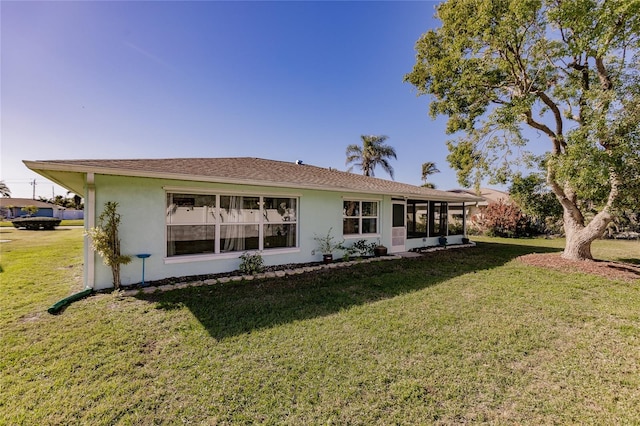 rear view of property with a yard