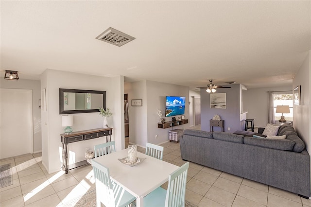 tiled dining space with ceiling fan