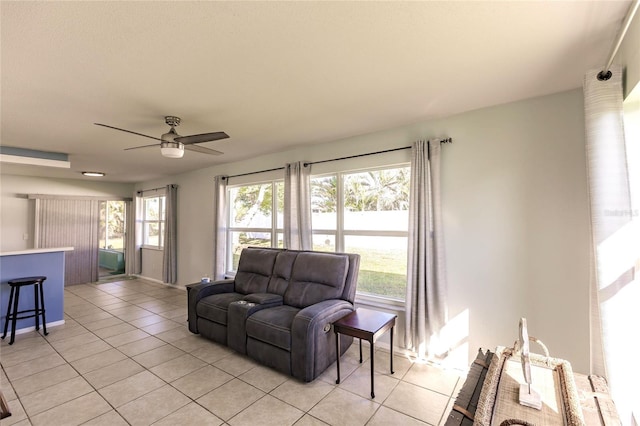 tiled living room featuring ceiling fan