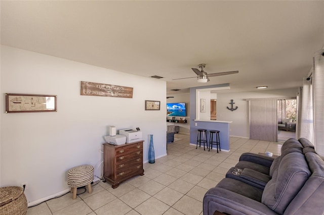 tiled living room with ceiling fan