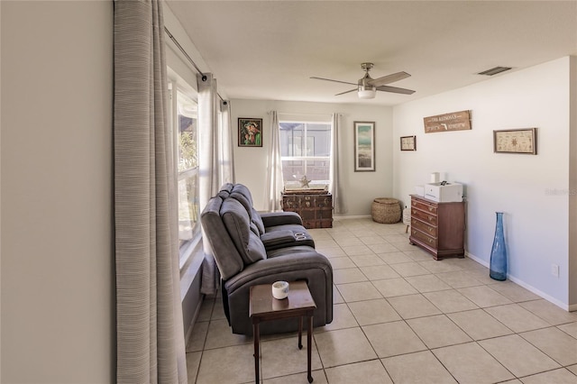 sitting room featuring ceiling fan and light tile patterned flooring