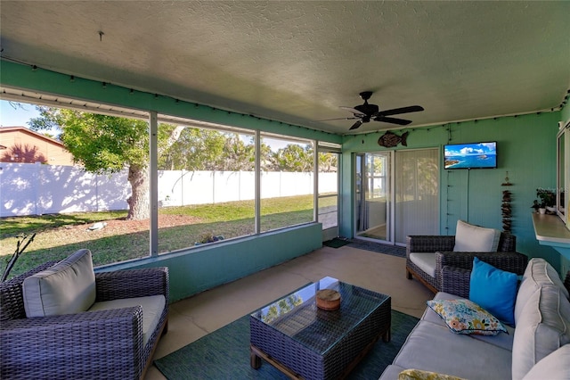 sunroom featuring ceiling fan