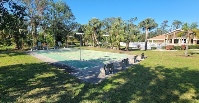 view of sport court featuring a yard