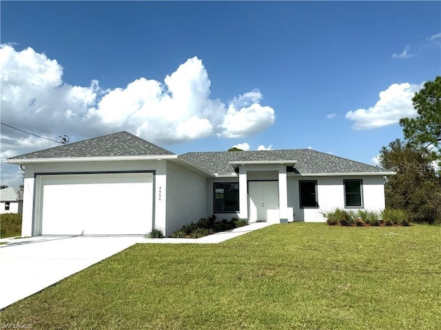 view of front of home with a front yard and a garage