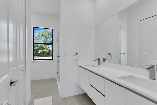 bathroom with a shower with door and vanity