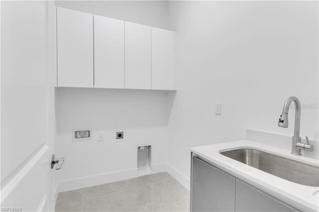 laundry room featuring sink, washer hookup, cabinets, hookup for an electric dryer, and light tile patterned floors