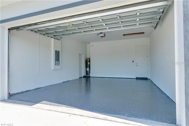 garage featuring water heater, a garage door opener, and electric panel