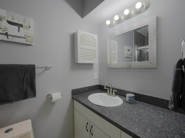 bathroom featuring vanity and toilet