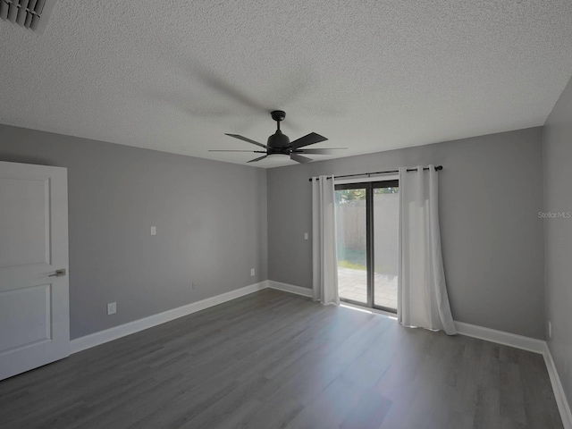 spare room with dark hardwood / wood-style floors, ceiling fan, and a textured ceiling