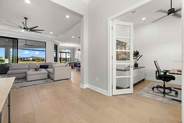 office with light wood-type flooring and ceiling fan