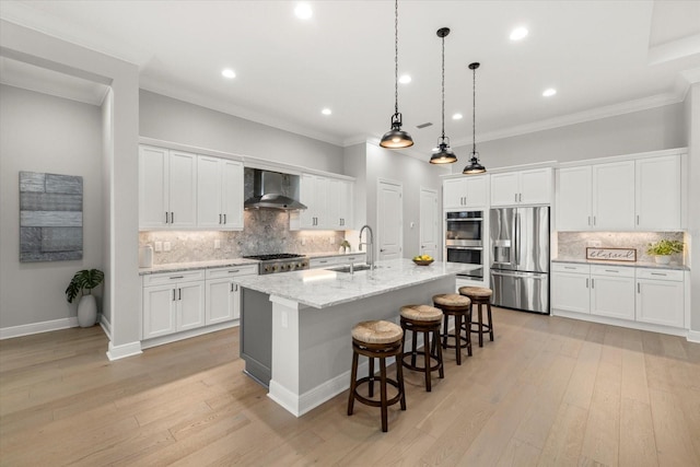 kitchen with white cabinetry, wall chimney range hood, and stainless steel appliances