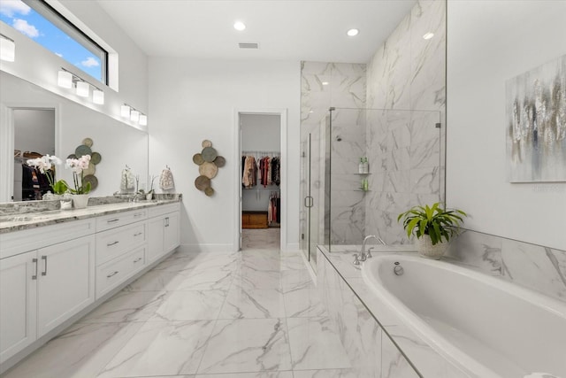 bathroom with vanity and independent shower and bath