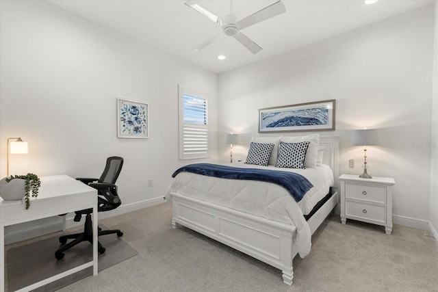 bedroom with ceiling fan and light carpet