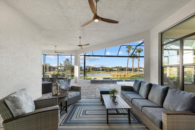 sunroom featuring a water view