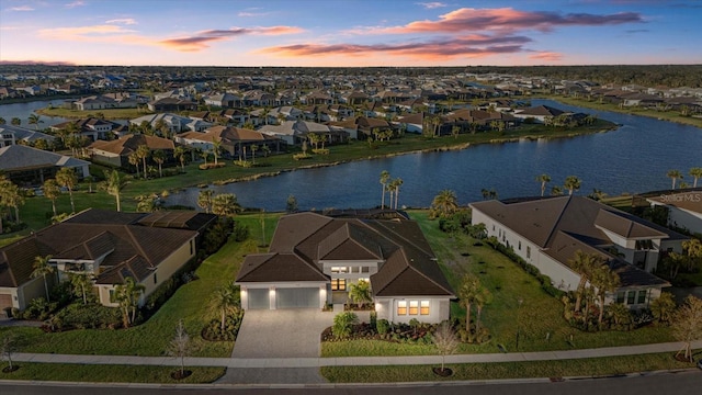 aerial view at dusk with a water view