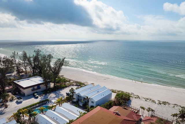 aerial view with a water view and a beach view