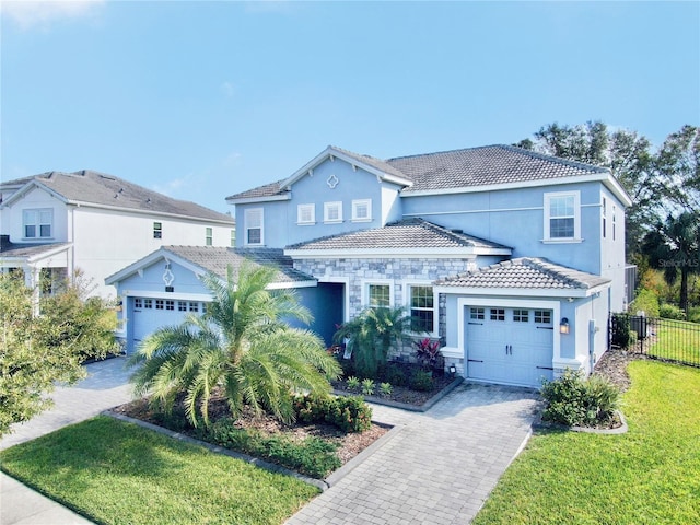 view of front of property featuring a garage and a front lawn