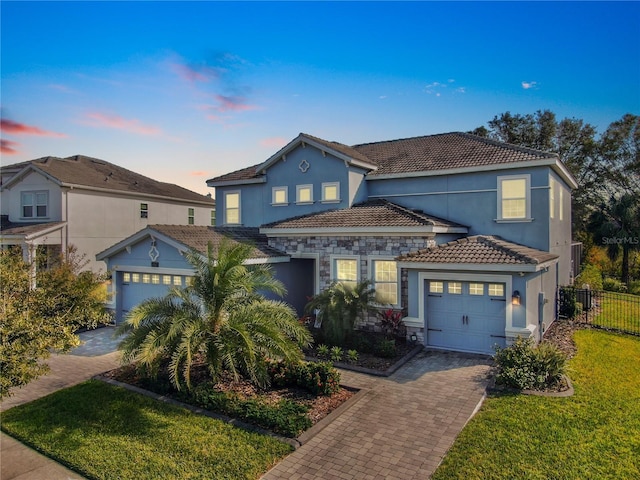 view of front of property with a lawn and a garage