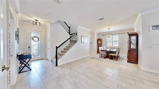 foyer featuring crown molding and an inviting chandelier