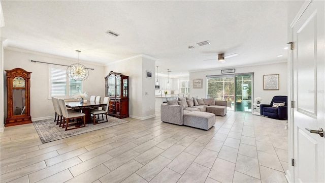 living room featuring ceiling fan with notable chandelier, plenty of natural light, and ornamental molding