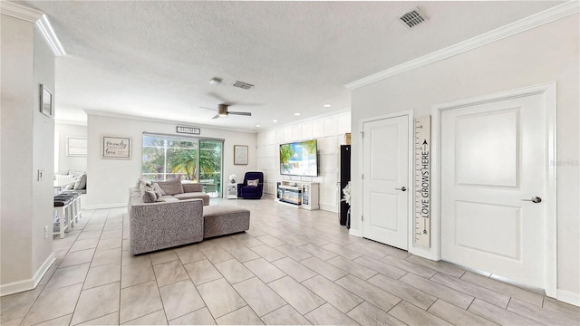 living room featuring ceiling fan, crown molding, and a textured ceiling