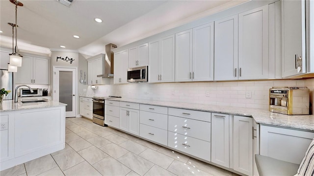 kitchen with backsplash, sink, appliances with stainless steel finishes, decorative light fixtures, and white cabinetry