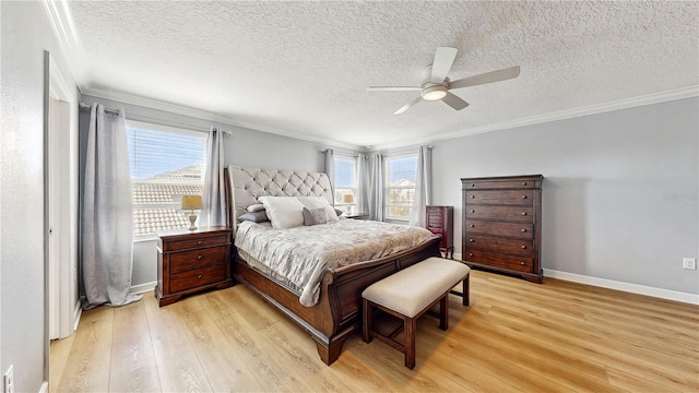 bedroom featuring a textured ceiling, light hardwood / wood-style flooring, ceiling fan, and ornamental molding