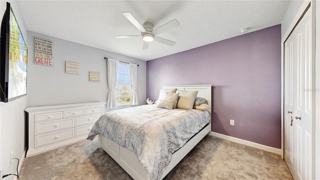 carpeted bedroom featuring a closet and ceiling fan