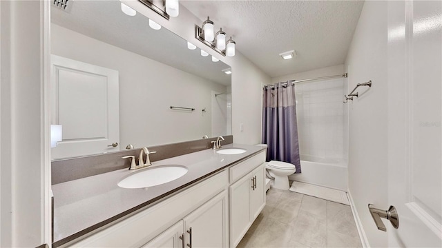 full bathroom with shower / bath combo, vanity, tile patterned flooring, toilet, and a textured ceiling