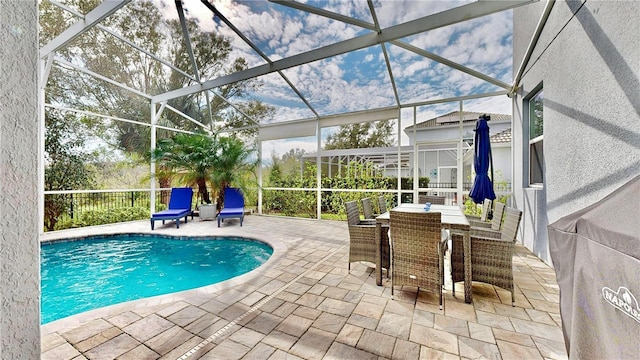 view of pool with a patio and glass enclosure