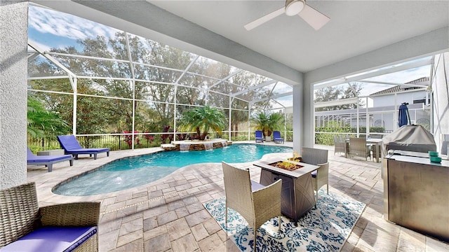 view of swimming pool featuring pool water feature, ceiling fan, a patio area, and an outdoor fire pit