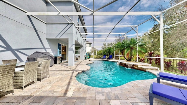 view of swimming pool with a lanai, a patio area, and pool water feature