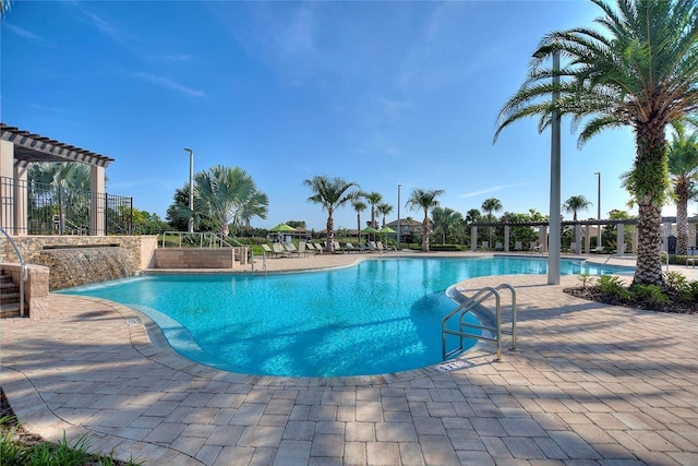 view of pool with pool water feature and a patio area