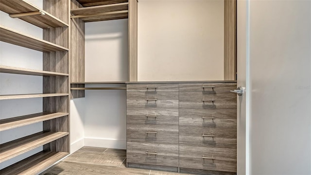 spacious closet featuring wood finish floors