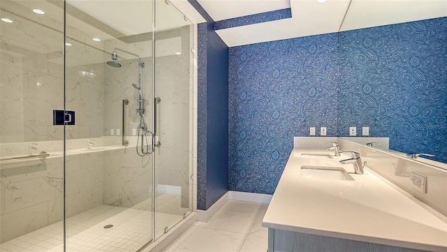 full bathroom with marble finish floor, a sink, a marble finish shower, and baseboards