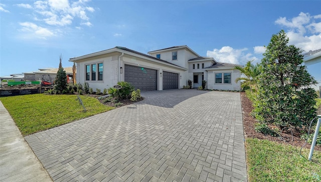 view of front of home featuring a front yard and a garage